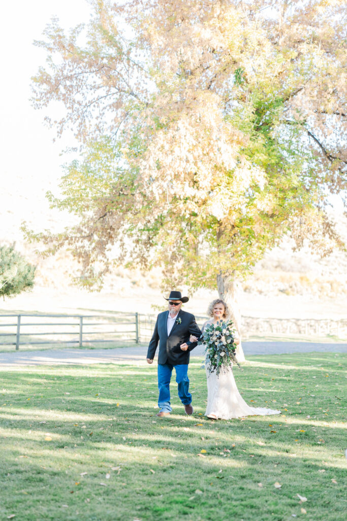 Bride walking down aisle outside