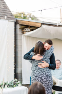 groom hugging friend at wedding 