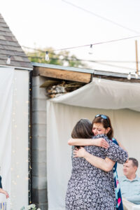 friend and mom hugging at wedding 