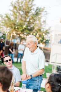 grandpa talking to couple at wedding 