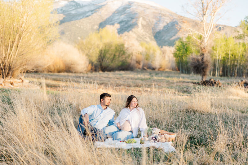 a photo of mom and dad having a picnic with the lamoille mountains in the background