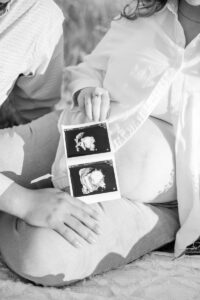 a mom holding her pictures of her baby in lamoille 