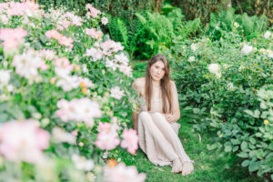Cathy is sitting by the roses