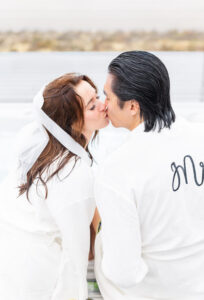 Bride and groom kissing at Ruby 360 Lodge in Lamoille, inside a hot tub with champagne. 