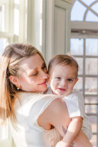 A mom looking at her baby as he is smiling 