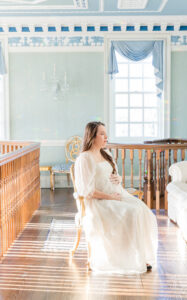 What to pack in hospital bag, a woman looking into the distance, holding her baby bump. 