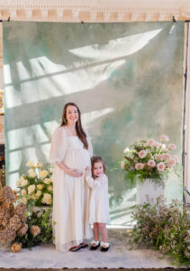 Mom and daughter standing together against a Willow Canvas 