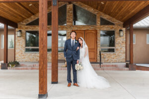 Bride and Groom standing in front of hotel