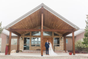 Bride and Groom holding each other in front of Ruby 360 Lodge 