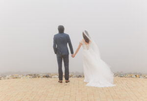 Bride and Groom standing in fog at Ruby 360 Lodge 