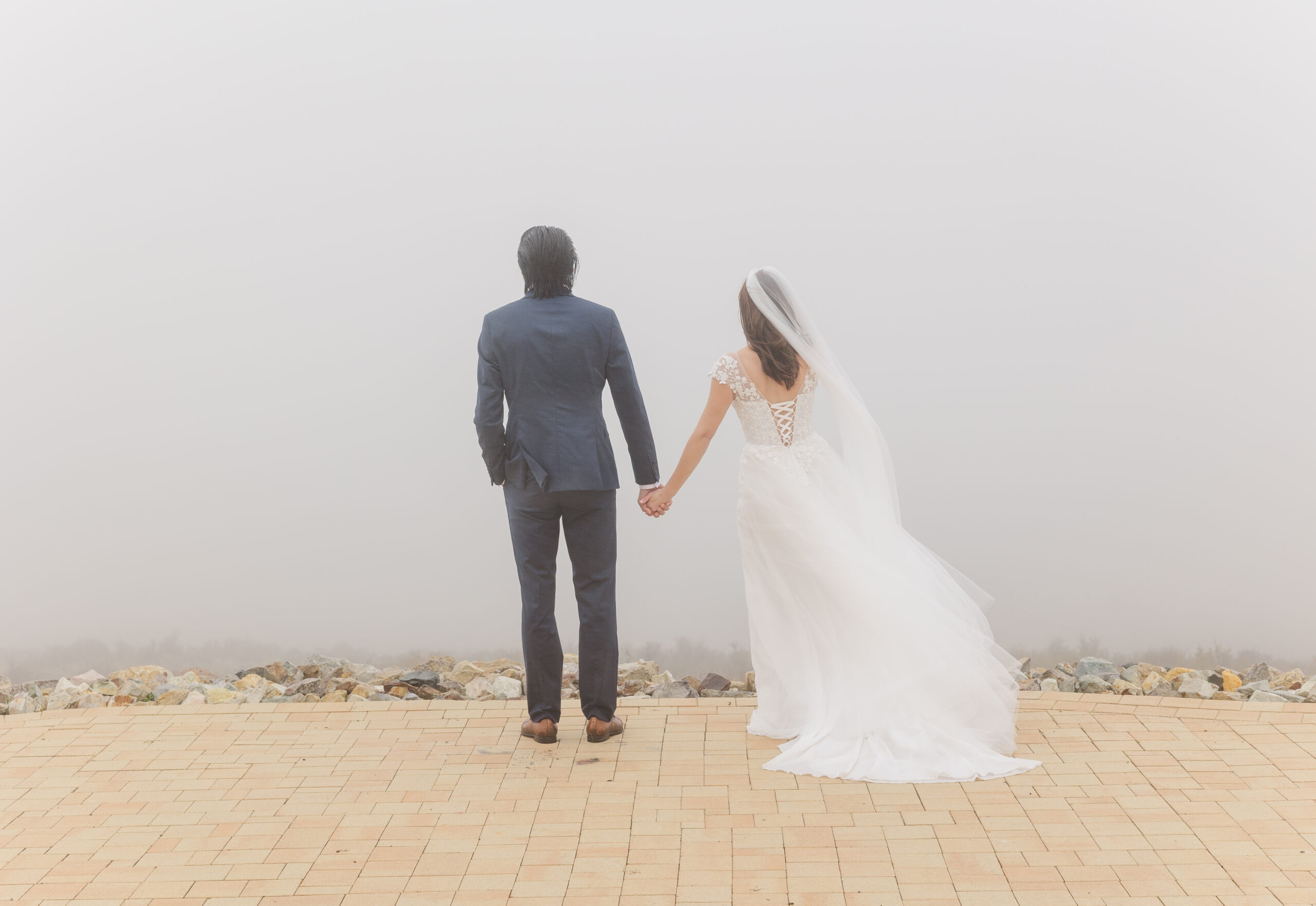 Bride and Groom standing in fog at Ruby 360 Lodge