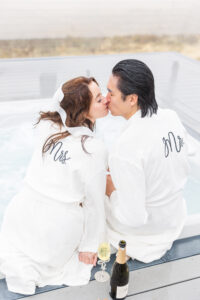 A bride and groom kissing in the Ruby 360 hot tub 