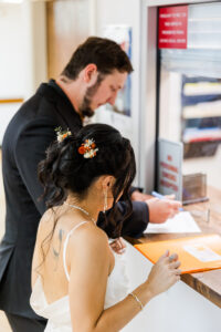 bride and groom signing court papers 