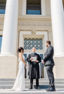 bride and groom standing on courthouse steps for my wedding portfolio 