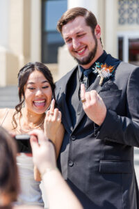 bride and groom flipping off camera 