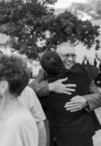 groom hugging grandpa