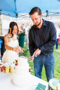 bride and groom cutting cake 
