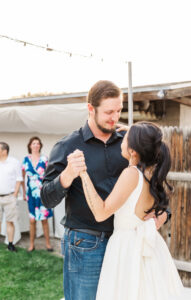 groom looking at bride while dancing 