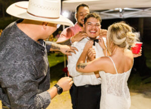 groom taking off shirt