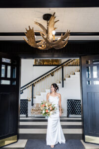 bride posing in front of door for wedding portfolio 